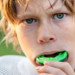 Boy putting in his mouth guard