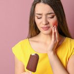 girl has hypersensitive teeth eats ice cream