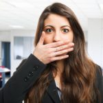 woman covers her mouth because she has bad breath